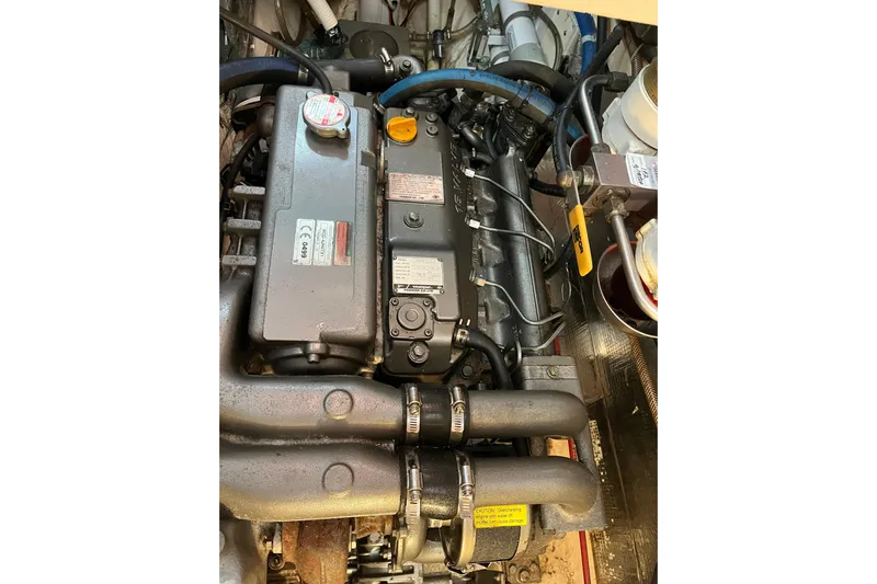 Wind Star Yacht Photos Pics Engine compartment of a 1986 Liberty 49, showcasing mechanical components and hoses.