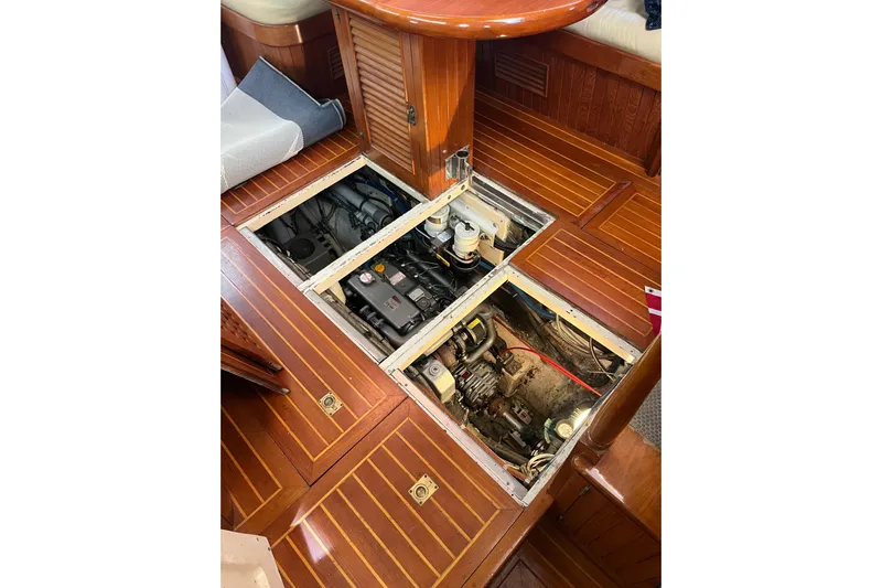Wind Star Yacht Photos Pics Engine compartment of 1986 Liberty 49 boat with wooden flooring and open access panels.