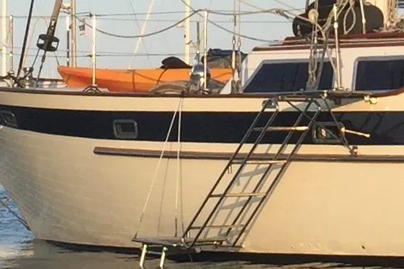 Wind Star Yacht Photos Pics Sailboat Liberty 49, 1986 model, with a ladder and orange kayak on deck.