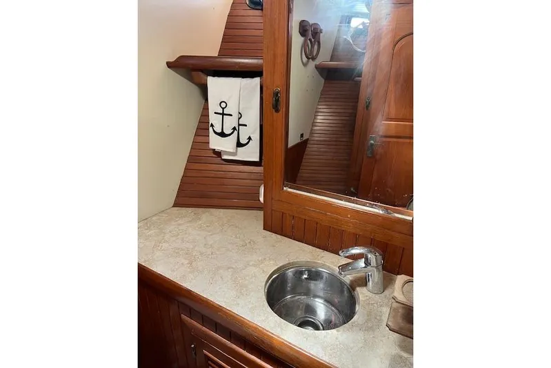 Wind Star Yacht Photos Pics 1986 Liberty 49 yacht bathroom with wooden accents and nautical-themed decor.