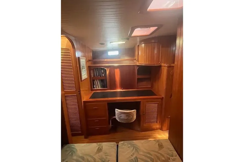 Wind Star Yacht Photos Pics Wooden interior of 1986 Liberty 49 yacht with desk and storage cabinets.