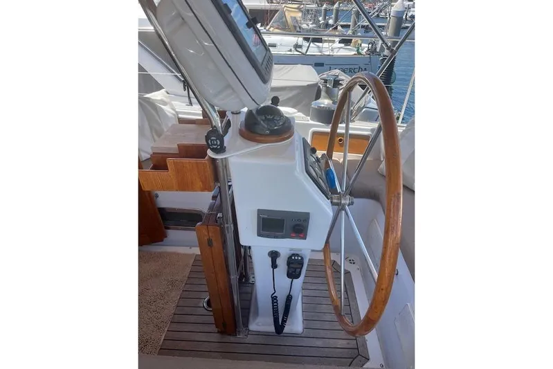 Wind Star Yacht Photos Pics Helm of 1986 Liberty 49 sailboat with wooden wheel and navigation equipment.