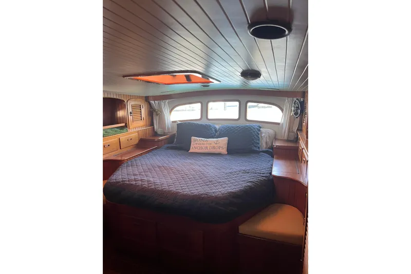 Wind Star Yacht Photos Pics Cozy cabin interior of 1986 Liberty 49 yacht with bed and wooden furnishings.