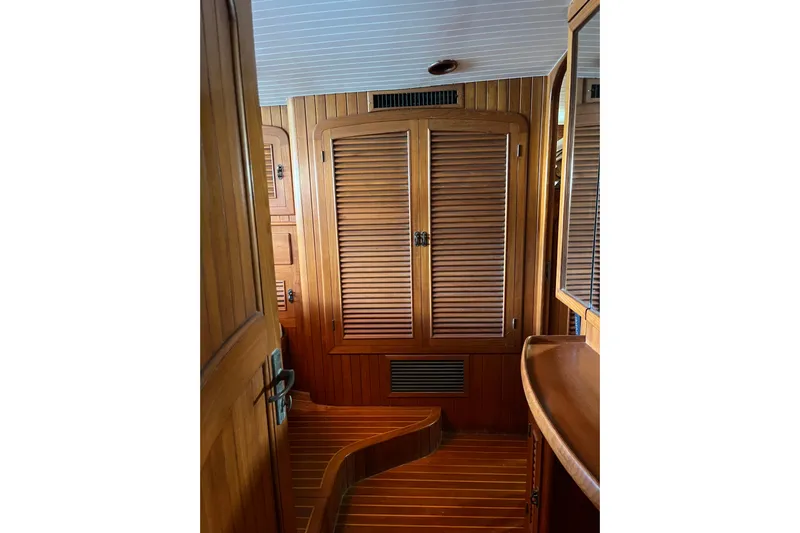 Wind Star Yacht Photos Pics Interior of 1986 Liberty 49 yacht with wooden cabinetry and flooring.