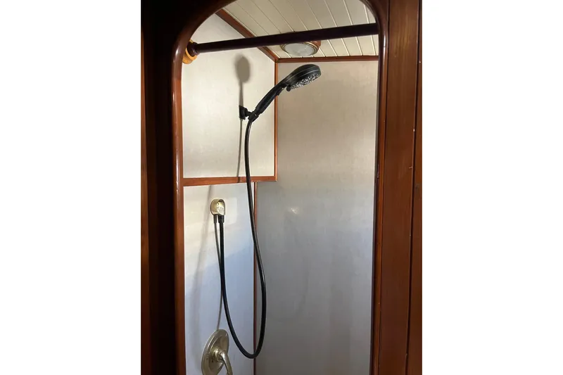 Wind Star Yacht Photos Pics 1986 Liberty 49 shower interior with wooden trim and handheld showerhead.