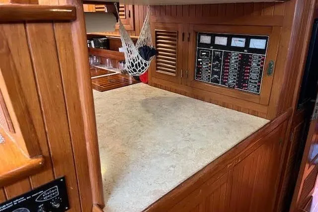 Wind Star Yacht Photos Pics 1986 Liberty 49 yacht interior with wooden cabinetry and control panel.