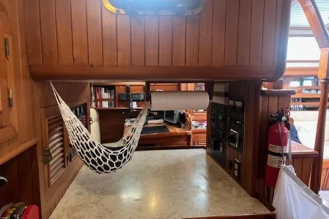 Wind Star Yacht Photos Pics 1986 Liberty 49 yacht interior with hammock, wooden paneling, and fire extinguisher.
