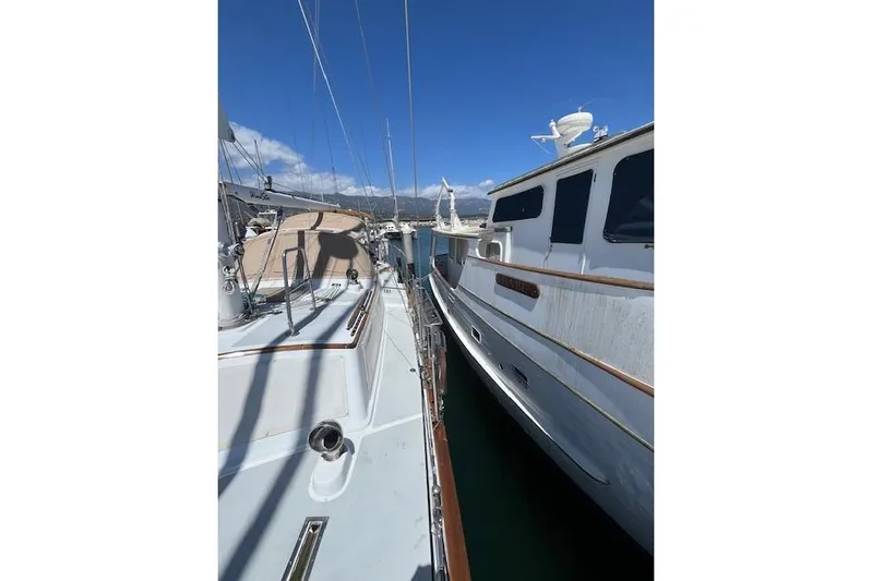 Wind Star Yacht Photos Pics Two boats docked side by side under a clear blue sky, Liberty 49, 1986 model.