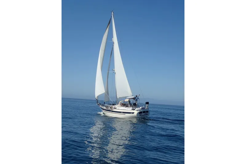Wind Star Yacht Photos Pics Sailing yacht Liberty 49 from 1986 on calm blue ocean waters.