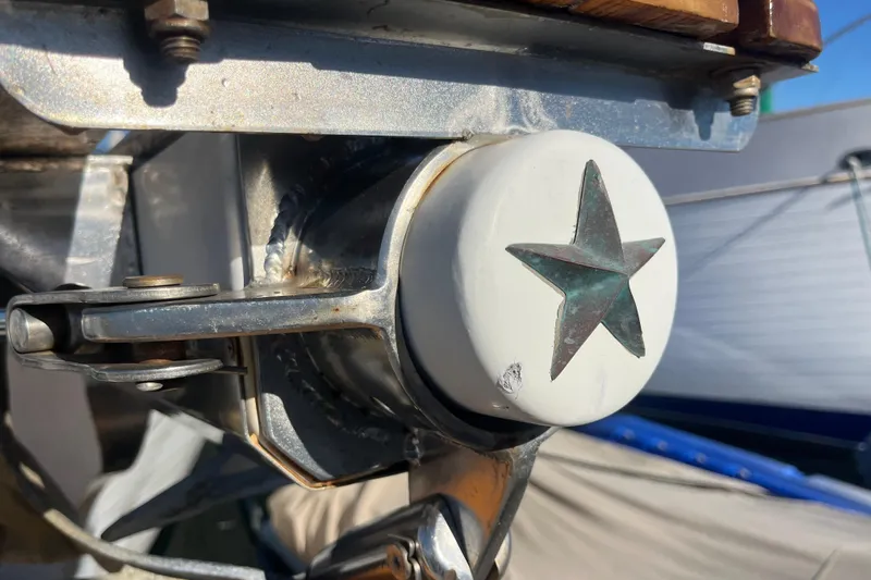 Wind Star Yacht Photos Pics Close-up of a 1986 Liberty 49 boat component with a star emblem.