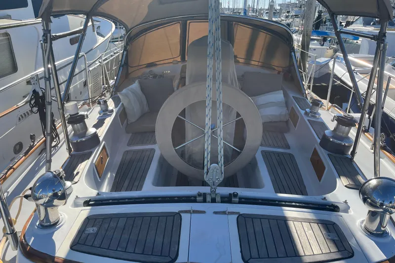 Wind Star Yacht Photos Pics 1986 Liberty 49 sailboat cockpit with wooden accents and steering wheel, docked at marina.