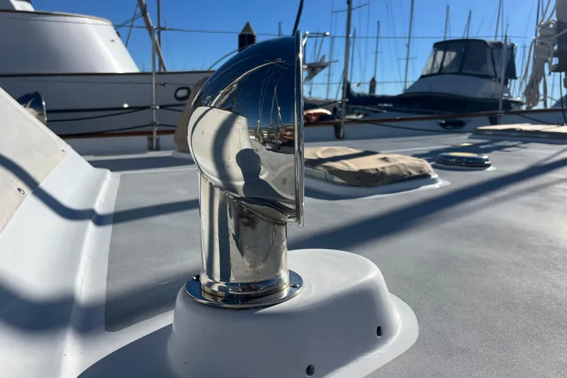 Wind Star Yacht Photos Pics Chrome vent on 1986 Liberty 49 yacht deck, marina background.
