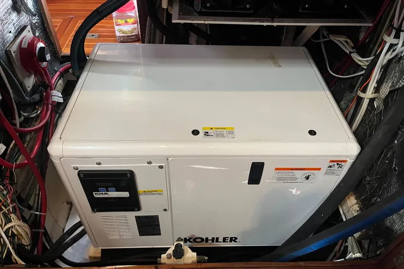 Wind Star Yacht Photos Pics Kohler generator in a 1986 Liberty 49 yacht engine room, surrounded by wiring.