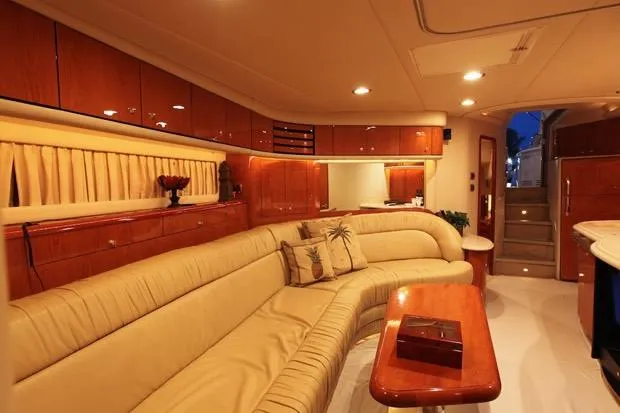 Good News Yacht Photos Pics Luxurious interior of 1998 Sea Ray 540 Sundancer yacht with elegant seating and wooden cabinetry.