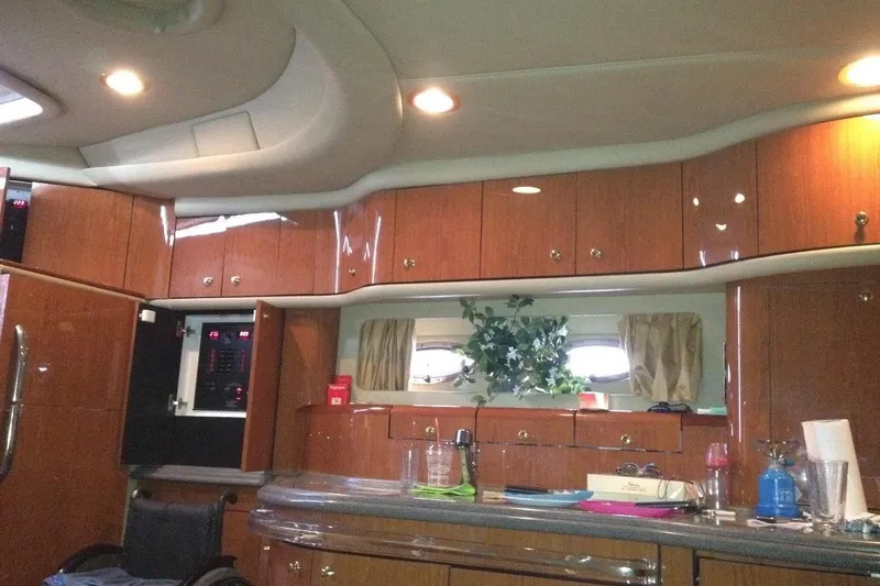 Good News Yacht Photos Pics Luxurious interior of a 1998 Sea Ray 540 Sundancer yacht with wooden cabinetry.