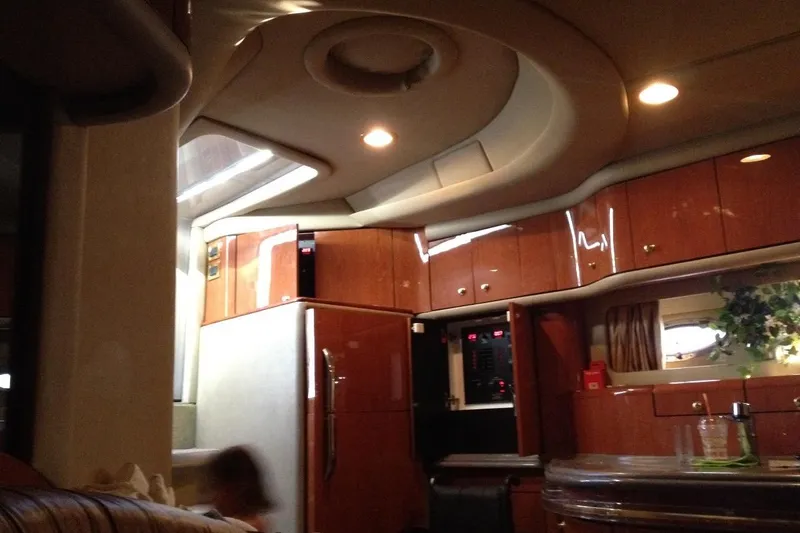 Good News Yacht Photos Pics Luxurious interior of a 1998 Sea Ray 540 Sundancer yacht with wood cabinetry and modern amenities.