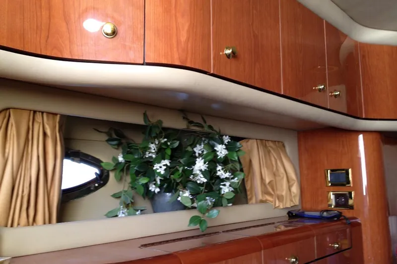 Good News Yacht Photos Pics Luxurious interior of 1998 Sea Ray 540 Sundancer with wood cabinets and floral decor.