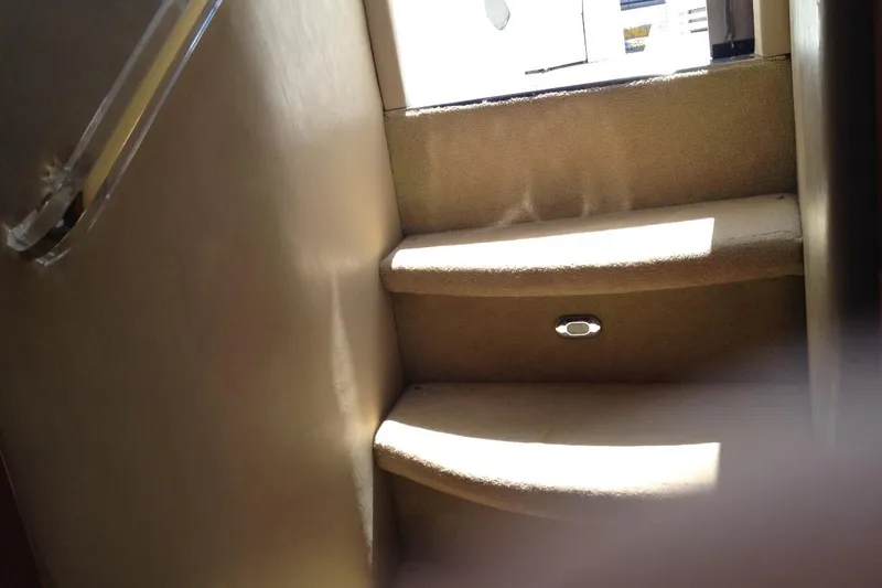 Good News Yacht Photos Pics Interior stairs of 1998 Sea Ray 540 Sundancer yacht, featuring carpeted steps and handrail.
