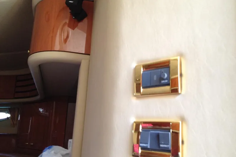 Good News Yacht Photos Pics Interior of 1998 Sea Ray 540 Sundancer with gold-trimmed switches and wood paneling.