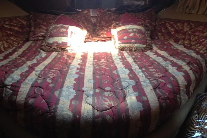 Good News Yacht Photos Pics Luxurious cabin interior of 1998 Sea Ray 540 Sundancer with patterned bedding.