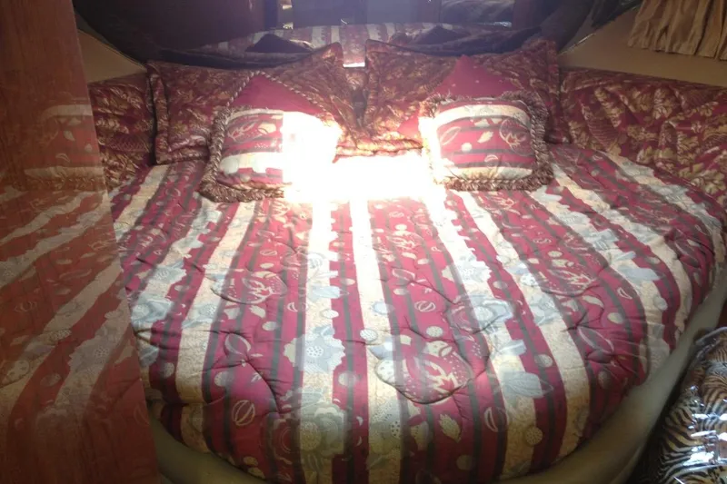 Good News Yacht Photos Pics Luxurious bedroom interior of 1998 Sea Ray 540 Sundancer yacht with patterned bedding.
