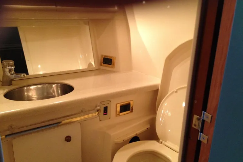 Good News Yacht Photos Pics Bathroom interior of 1998 Sea Ray 540 Sundancer yacht, featuring sink and toilet.