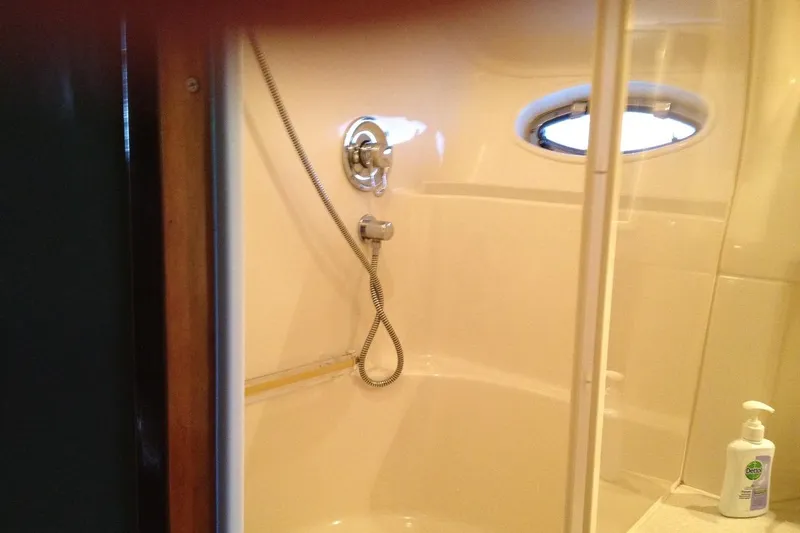 Good News Yacht Photos Pics Shower area in 1998 Sea Ray 540 Sundancer yacht with porthole and soap dispenser.