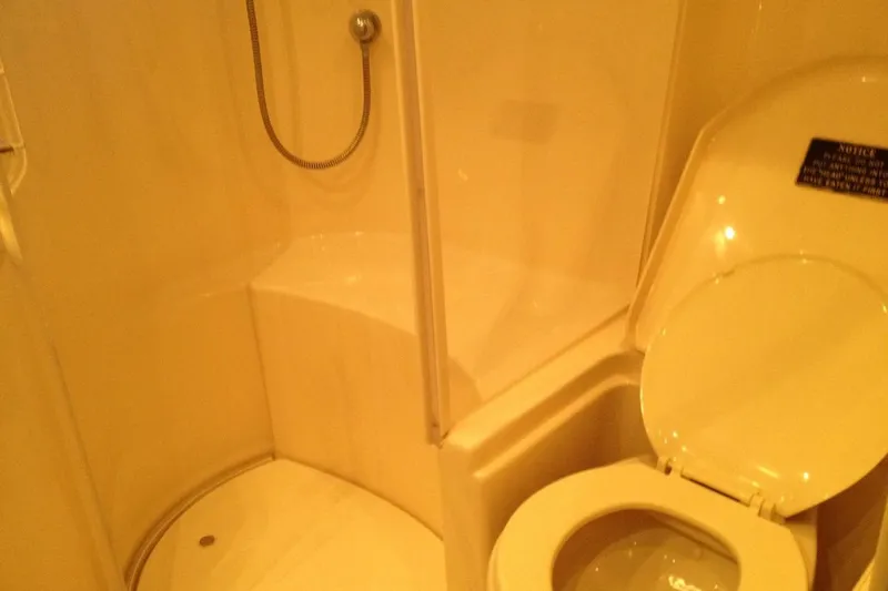 Good News Yacht Photos Pics Bathroom interior of 1998 Sea Ray 540 Sundancer yacht with shower and toilet.