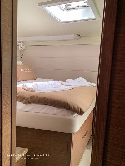Duolife Yacht Yacht Photos Pics Luxurious cabin interior of 2019 Lagoon 620 yacht with cozy bedding and natural light.