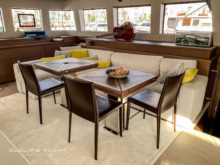 Duolife Yacht Yacht Photos Pics Luxurious interior of 2019 Lagoon 620 yacht with elegant dining area and plush seating.