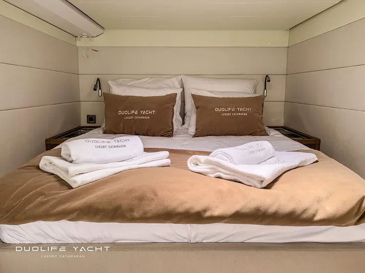 Duolife Yacht Yacht Photos Pics Luxurious bedroom interior on a 2019 Lagoon 620 yacht with plush bedding and towels.