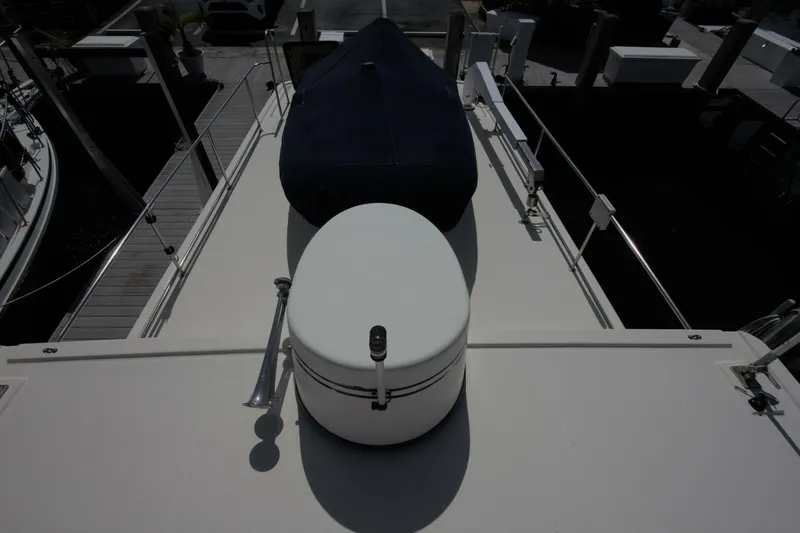 Hercules Yacht Photos Pics Nordic Tug 42 Millennium 2000 boat deck with covered equipment and railing.