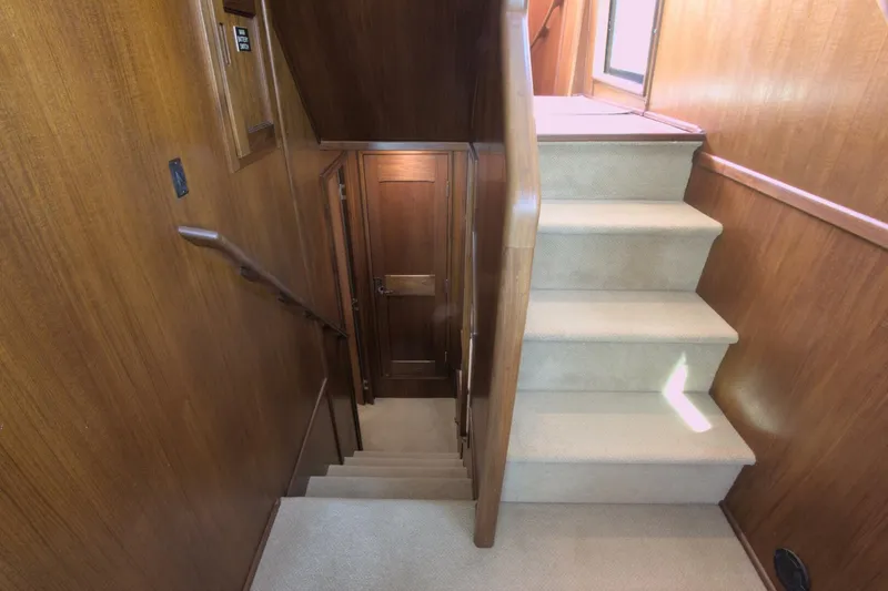 Hercules Yacht Photos Pics Staircase inside 2000 Nordic Tug 42 Millennium with wooden paneling and carpeted steps.