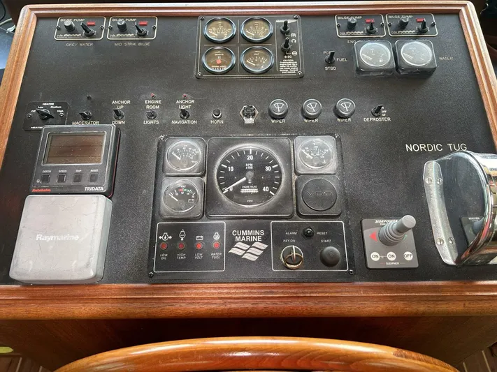 Hercules Yacht Photos Pics Control panel of a 2000 Nordic Tug 42 Millennium boat with various gauges and switches.