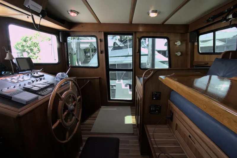 Hercules Yacht Photos Pics Interior of 2000 Nordic Tug 42 Millennium, featuring helm and wooden furnishings.