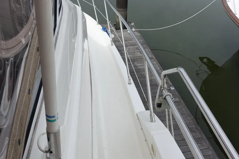  Yacht Photos Pics 2001 Silverton 410 Sport Bridge yacht docked, showing deck and railing details.