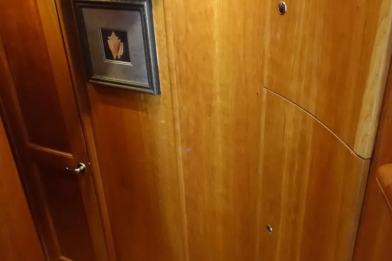  Yacht Photos Pics Interior of 2001 Silverton 410 Sport Bridge with wooden paneling and framed artwork.