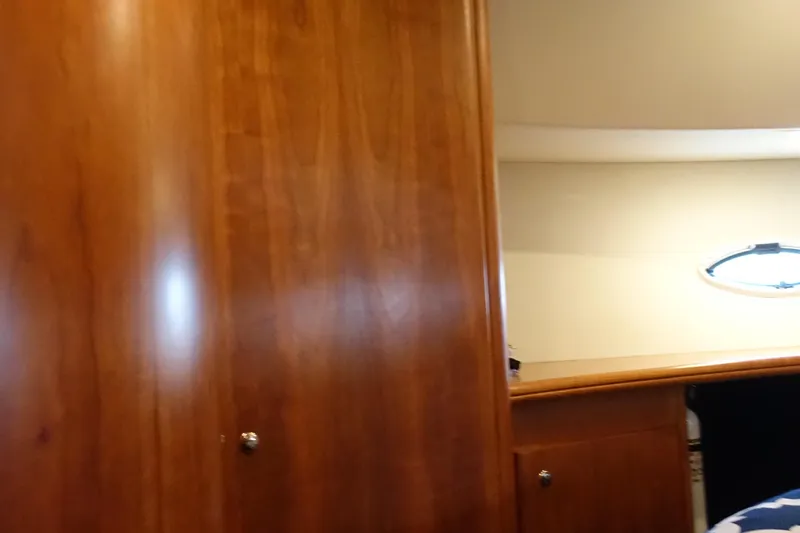  Yacht Photos Pics Interior of 2001 Silverton 410 Sport Bridge with wooden cabinetry and porthole window.