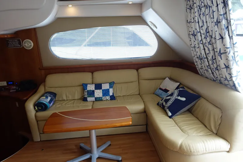  Yacht Photos Pics Interior of 2001 Silverton 410 Sport Bridge with beige leather seating and nautical decor.