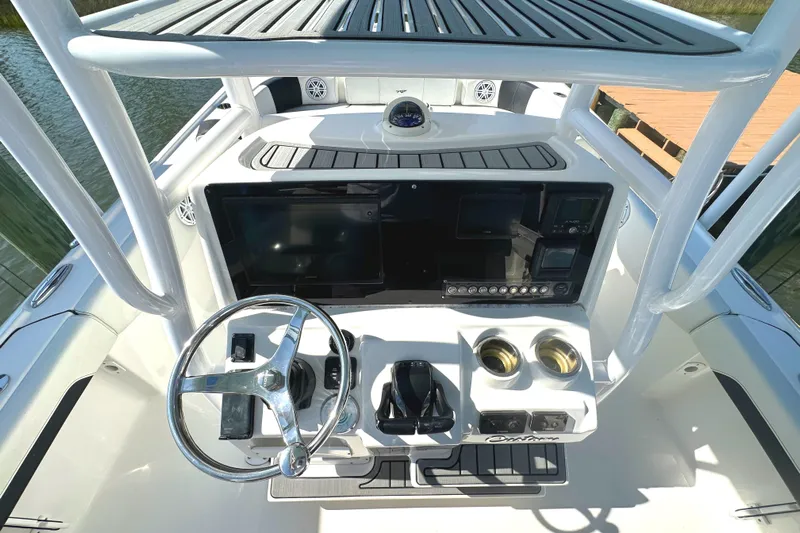  Yacht Photos Pics 2021 Tidewater 2700 Carolina Bay boat console with steering wheel and navigation controls.