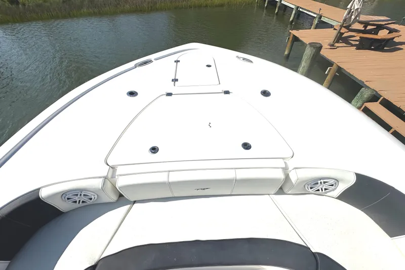  Yacht Photos Pics 2021 Tidewater 2700 Carolina Bay boat bow near dock, featuring sleek design and speakers.