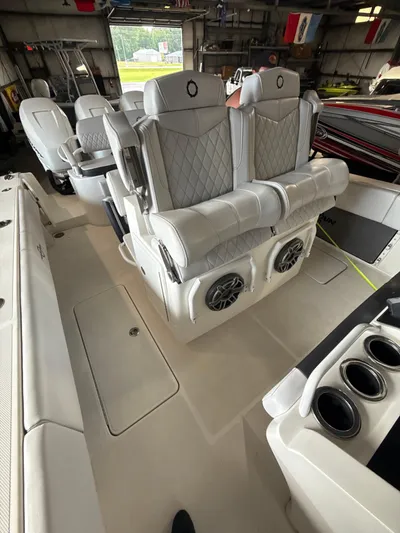  Yacht Photos Pics 2023 Fountain 34 CC boat interior with luxurious seating and built-in speakers.