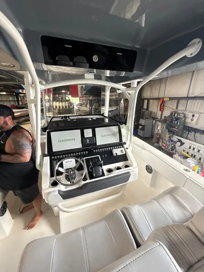  Yacht Photos Pics 2023 Fountain 34 CC boat interior with Garmin navigation system and steering console.