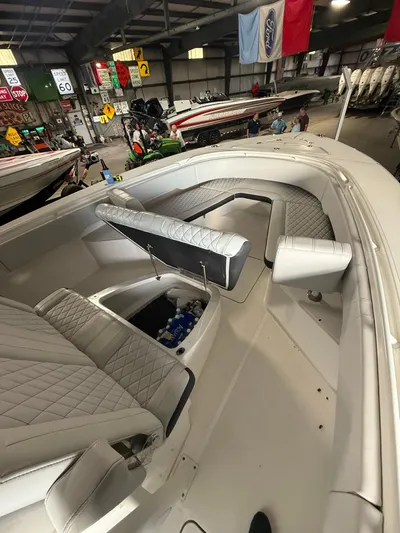  Yacht Photos Pics 2023 Fountain 34 CC boat interior with quilted seating and storage compartment in showroom.