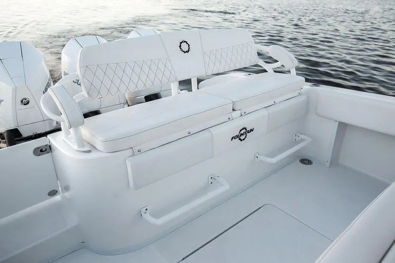 Fountain 34 Cc Yacht Photos Pics 2023 Fountain 34 CC boat interior with white seating and ocean backdrop.