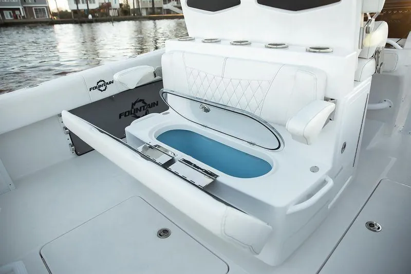 Fountain 34 Cc Yacht Photos Pics 2023 Fountain 34 CC boat interior with seating and storage, featuring sleek white design.
