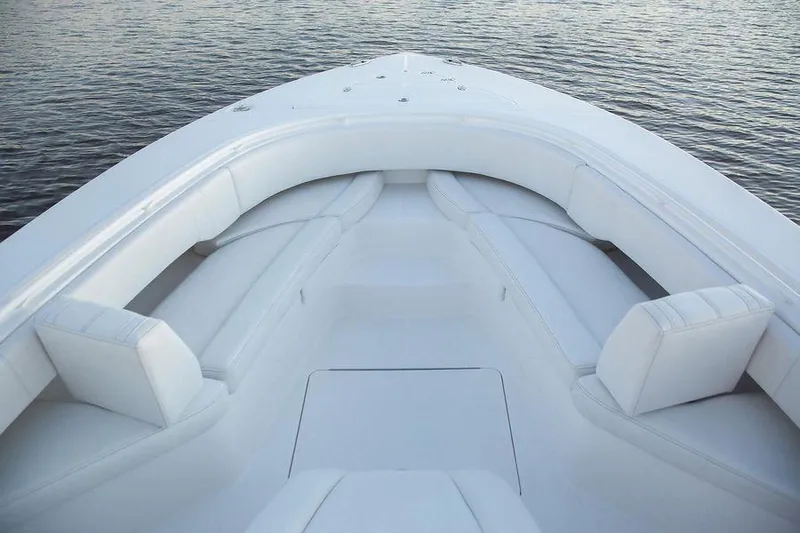 Fountain 34 Cc Yacht Photos Pics 2023 Fountain 34 CC boat with spacious white seating on calm water.