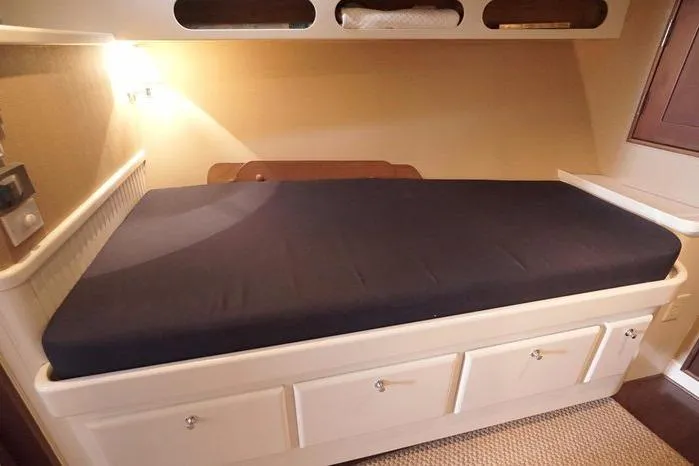 Faith Yacht Photos Pics Cozy cabin bed in 2003 Huckins Atlantic 44 yacht with storage drawers.
