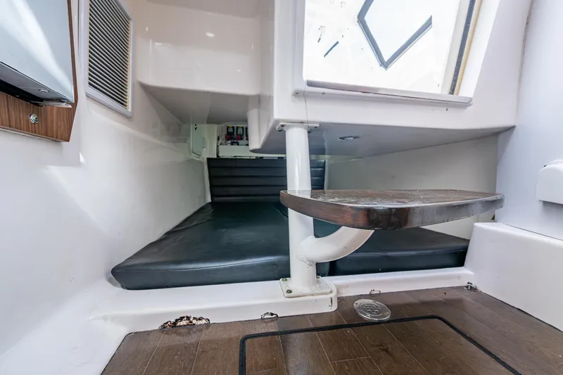 Kirby 107 Yacht Photos Pics 2014 Everglades 350LX cabin interior with wooden flooring and cushioned seating.
