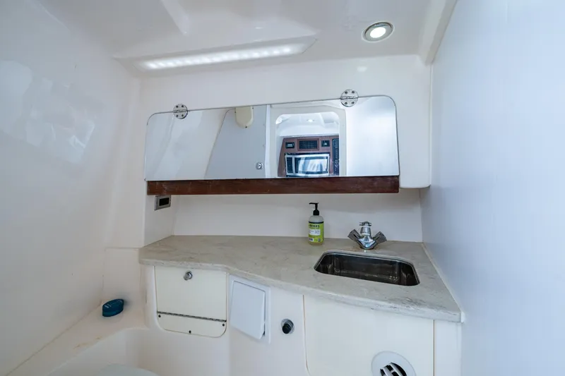 Kirby 107 Yacht Photos Pics 2014 Everglades 350LX boat bathroom with sink, mirror, and countertop.